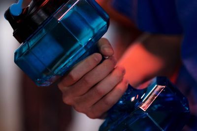 Close-up of a hand gripping a dumbbell with focus.