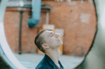 Side profile of a man breathing deeply before an exercise.